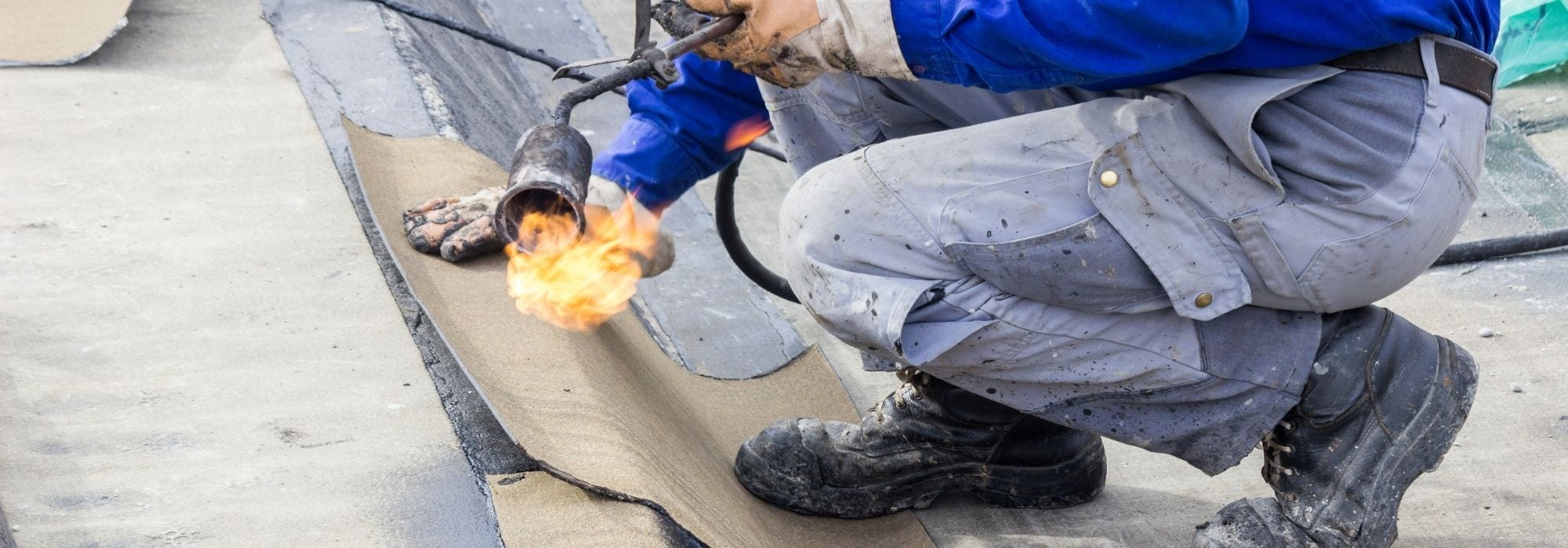 Rope access technician repairing a high-rise external wall